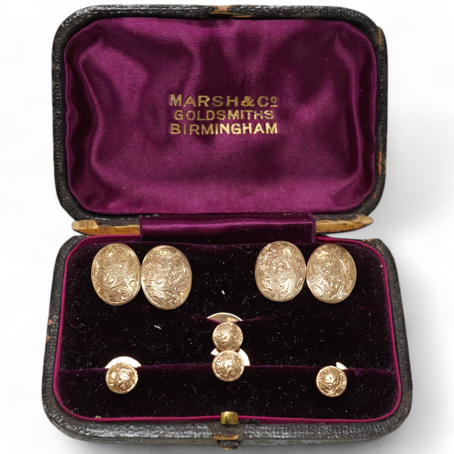 A cased early 20th century engraved 9ct six piece dress stud set, 4.9 grams. Condition - fair